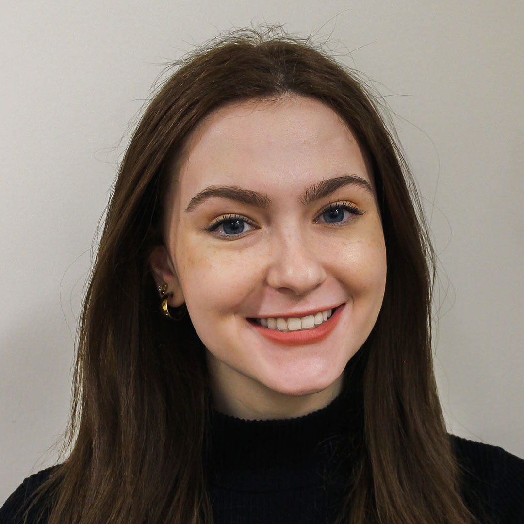 Headshot of Caroline Mooney with an friendly smile and big blue eyes.