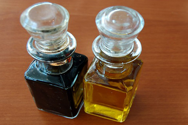 two glass bottles of salad dressing