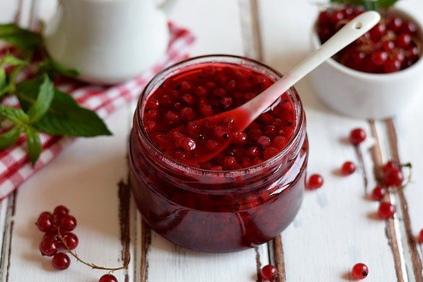 jar of red jam with currant berries