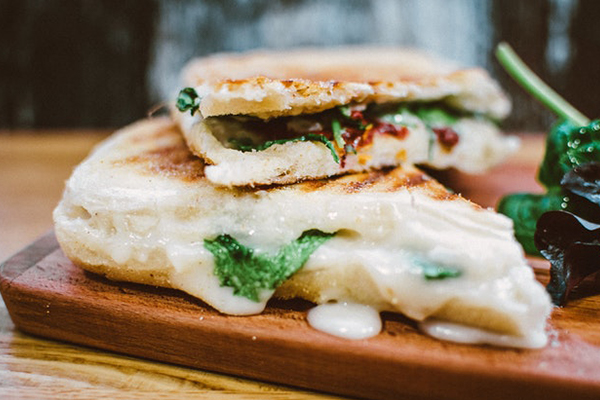 sandwich halves on wooden board
